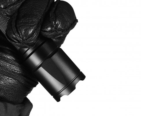 black glove holding a black tactical flashlight camping lanterns